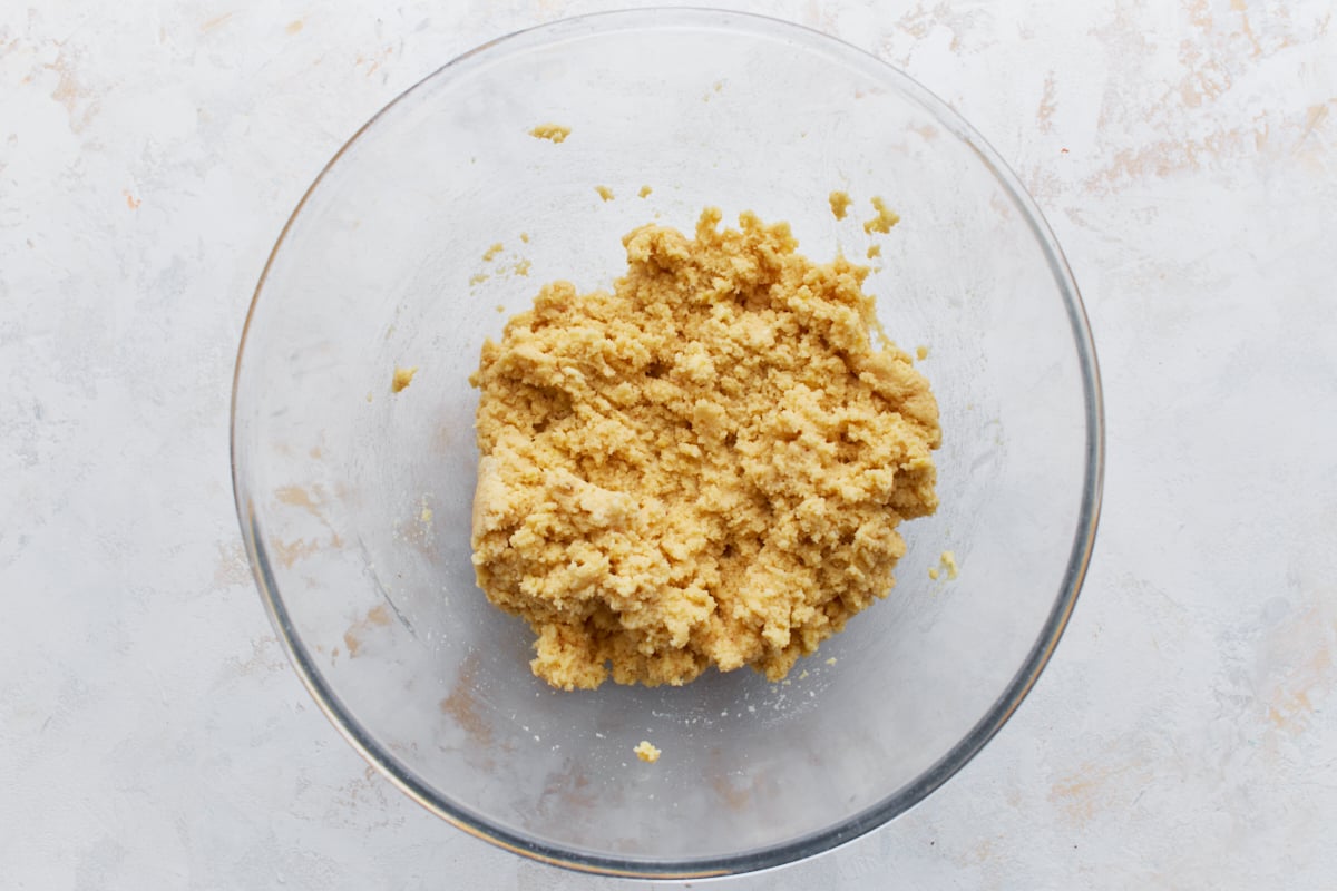 Fully mixed biscuit dough in a clear glass bowl, ready to scoop.