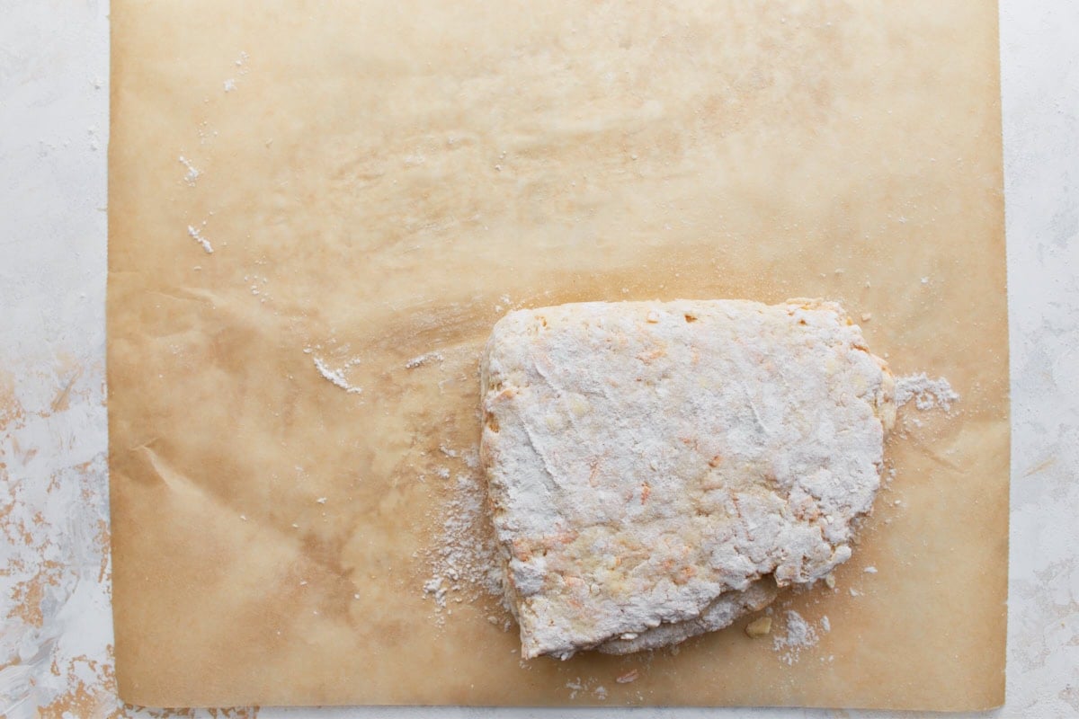 Biscuit dough folded once more, forming a smaller rectangle to enhance lift and structure.