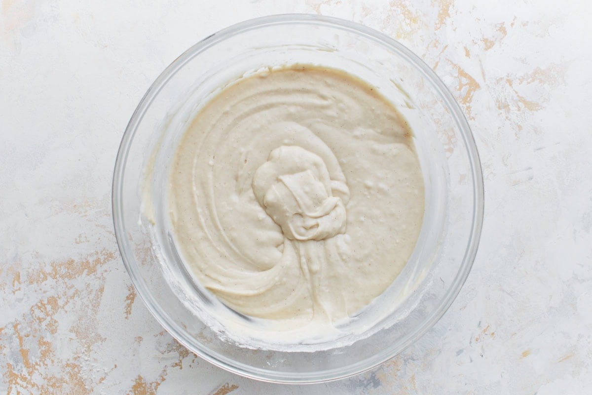 A bowl of smooth gluten-free Bisquick batter, ready to be poured over the casserole base.