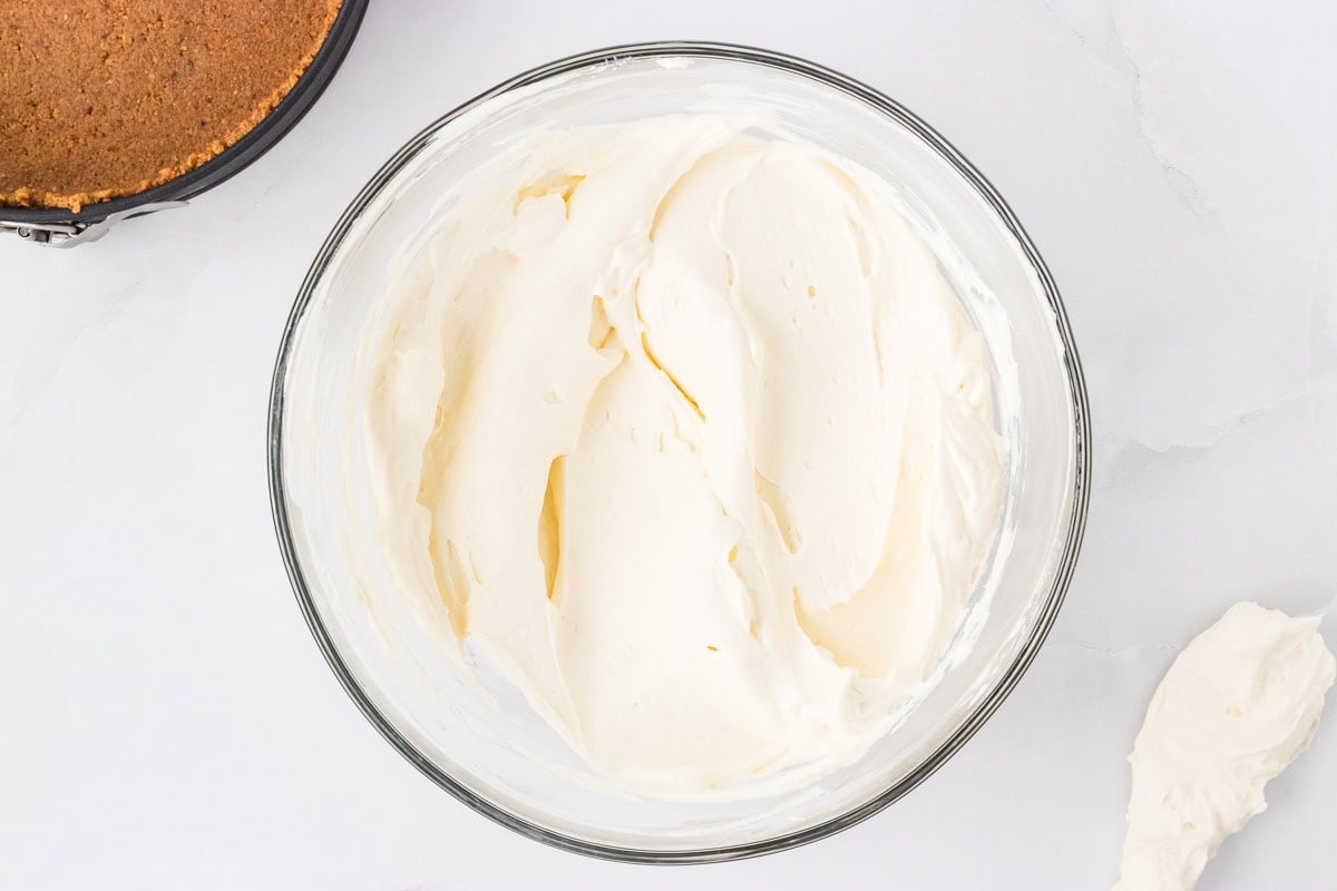 Smooth and creamy cheesecake filling in a mixing bowl, ready to be poured into the crust.