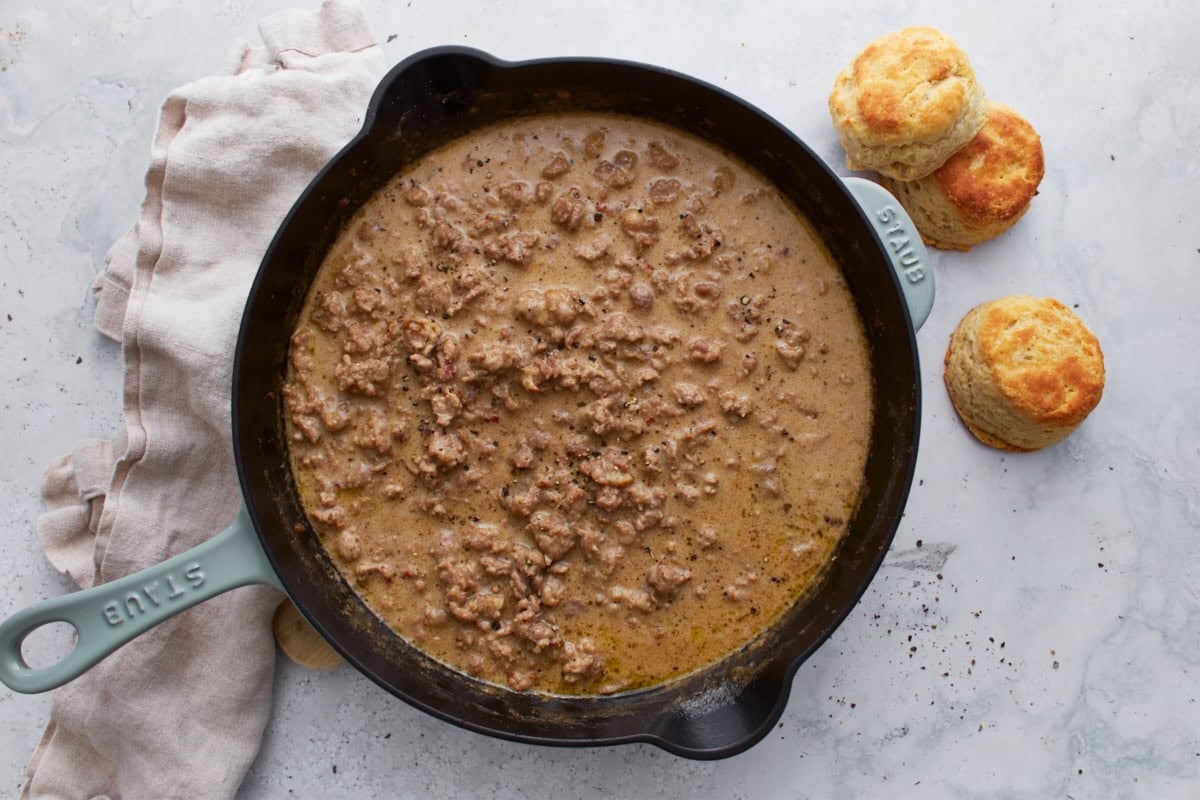 Fully cooked gluten-free sausage gravy in a skillet, with a creamy, rich texture.