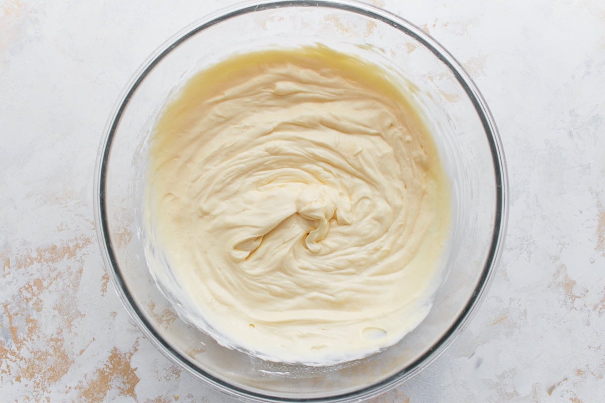 Keto cheesecake filling after eggs, vanilla, lemon juice, and sour cream have been mixed in.
