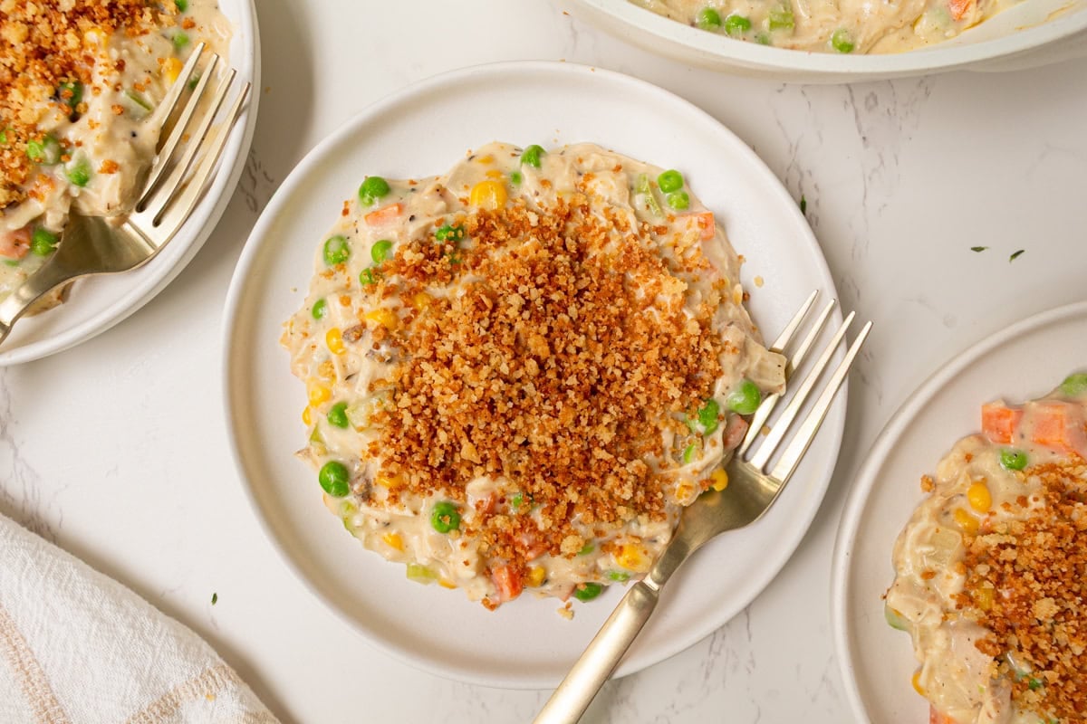 Plated serving of crustless chicken pot pie topped with golden toasted breadcrumbs and ready to eat.