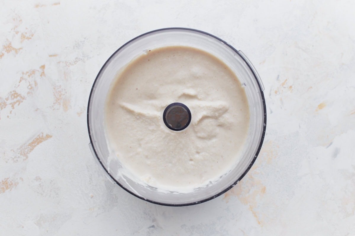 Smooth blended cashew cream in a food processor bowl, ready to be stirred into the vegan vodka sauce.