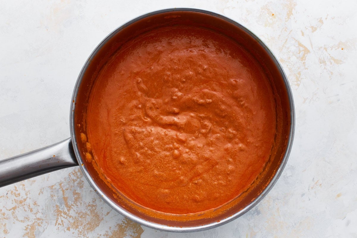 Vegan vodka sauce blended smooth and creamy, simmering in a skillet.
