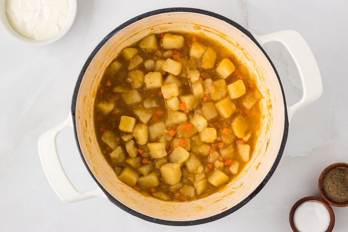 Cooked potatoes and vegetables thickened in the broth, forming the hearty base for the gluten-free potato soup.