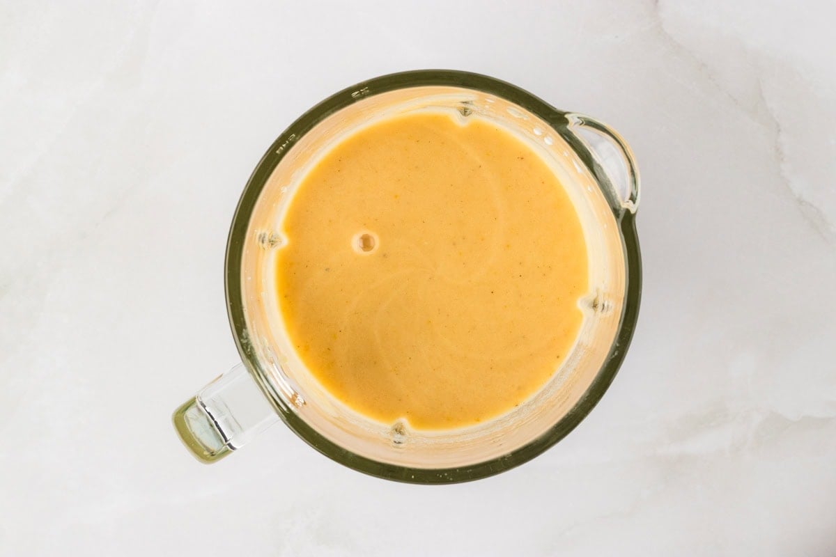 Half of the soup blended until smooth in a blender, creating a creamy texture without using flour.