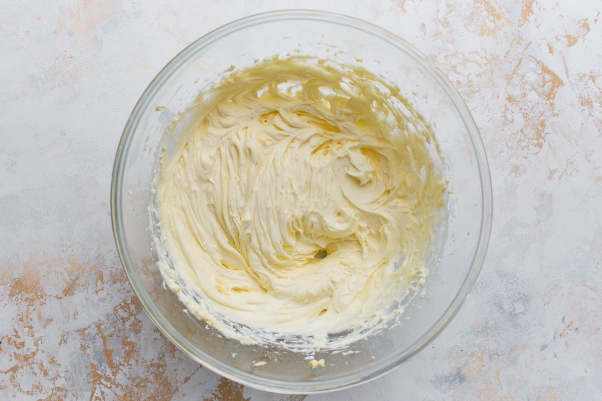 Bowl of smooth, fluffy cream cheese frosting after mixing.
