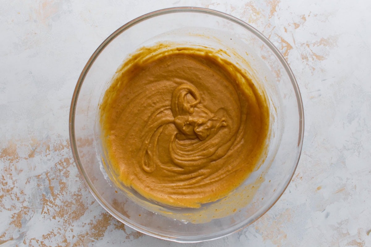Smooth pumpkin waffle batter in a bowl ready to cook.