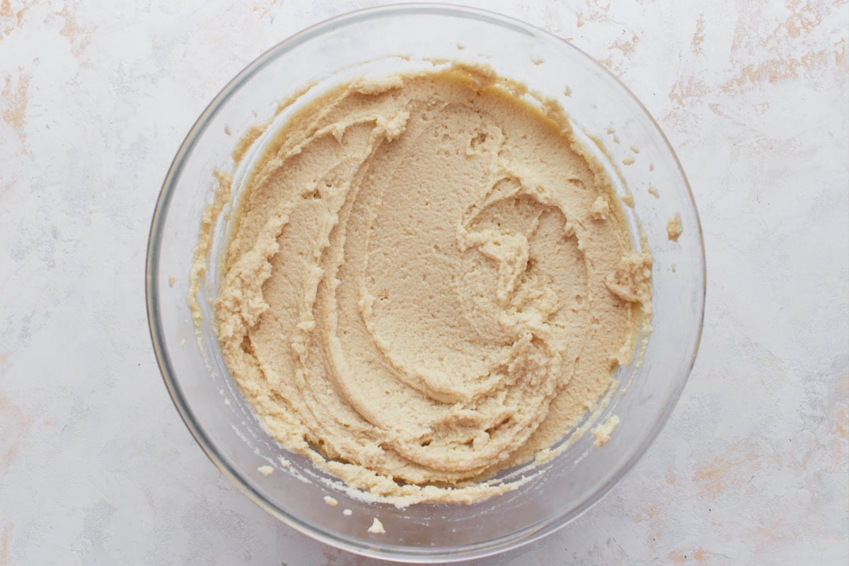 Smooth, spreadable gluten-free masa dough in a glass bowl, ready to use.