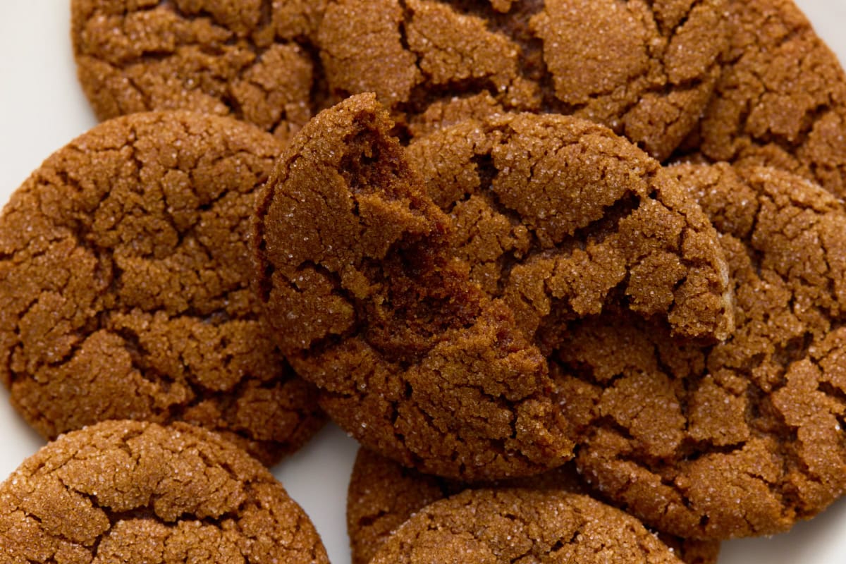 Close-up of a gluten-free gingersnap showing its crackled, chewy texture.