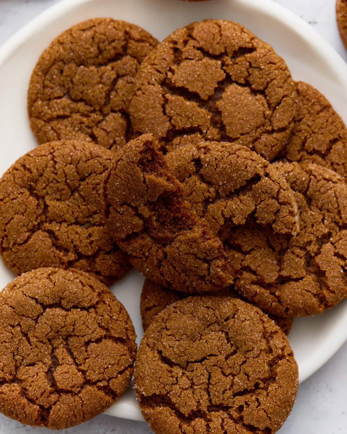 A plate of gluten-free gingersnaps with crisp, crackled tops.