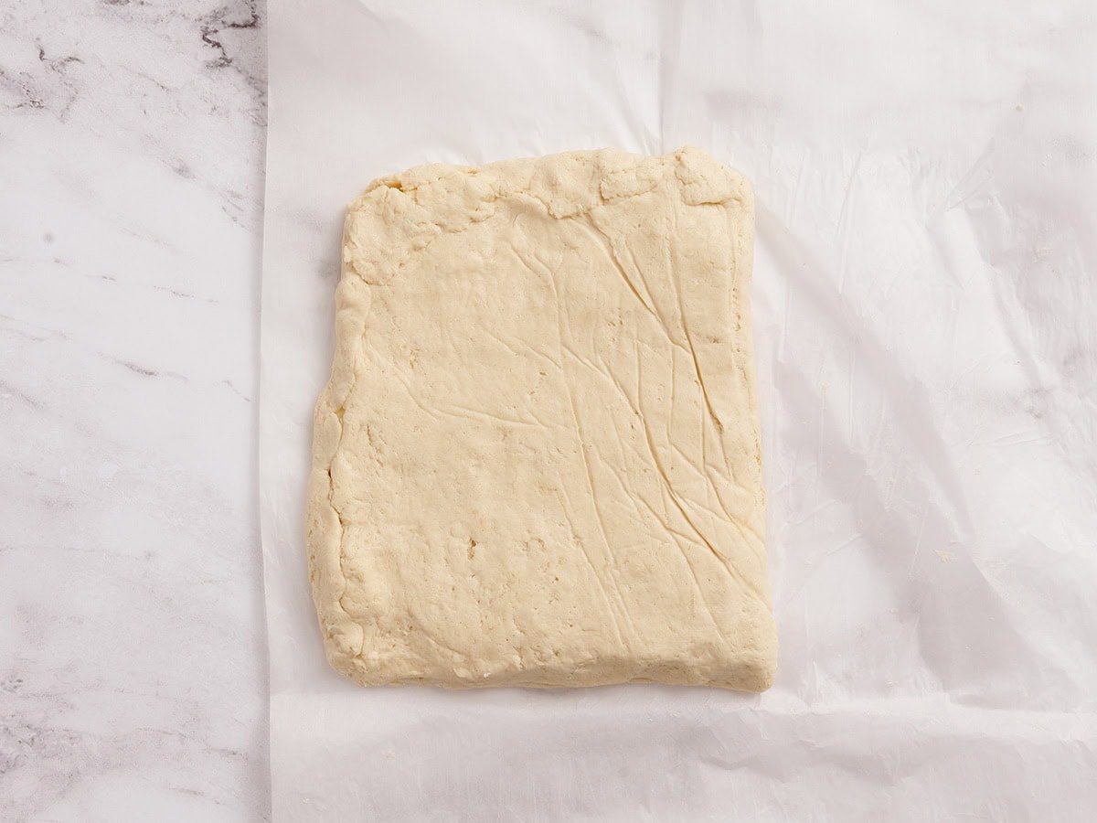 Gluten free dough folded over the butter block and sealed around the edges before chilling.