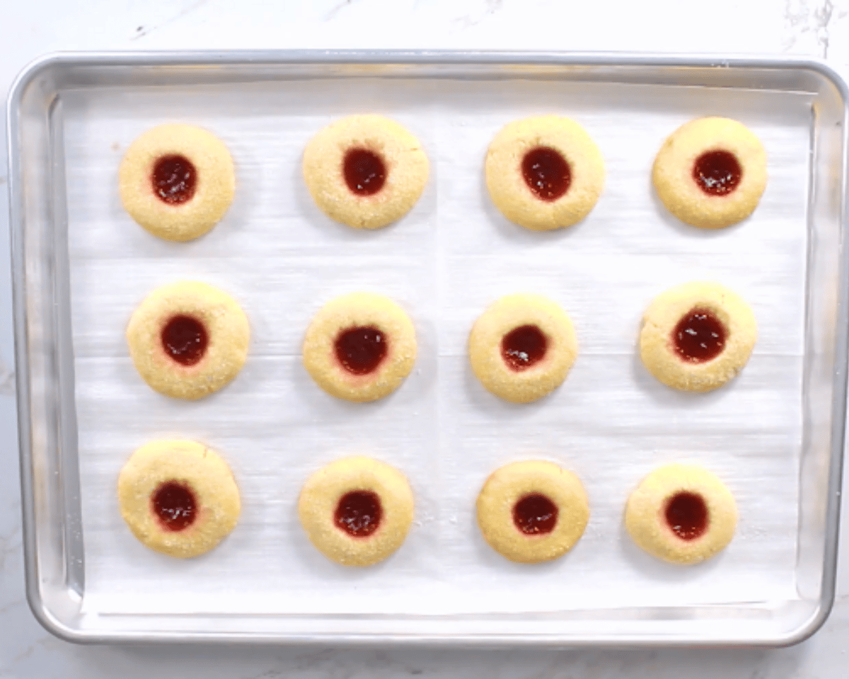gluten-free thumbprint cookies on a cookie sheet before going into oven
