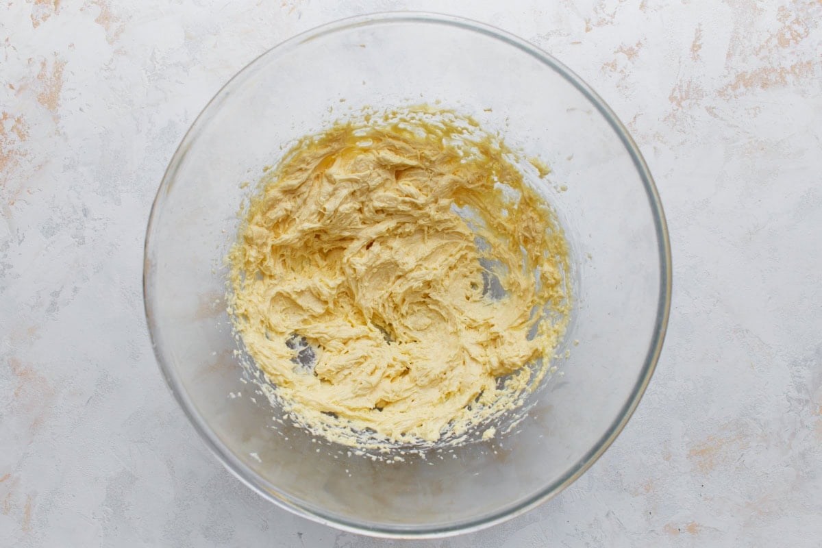 Butter, sugar, egg, and vanilla mixed together until smooth for almond flour sugar cookies.