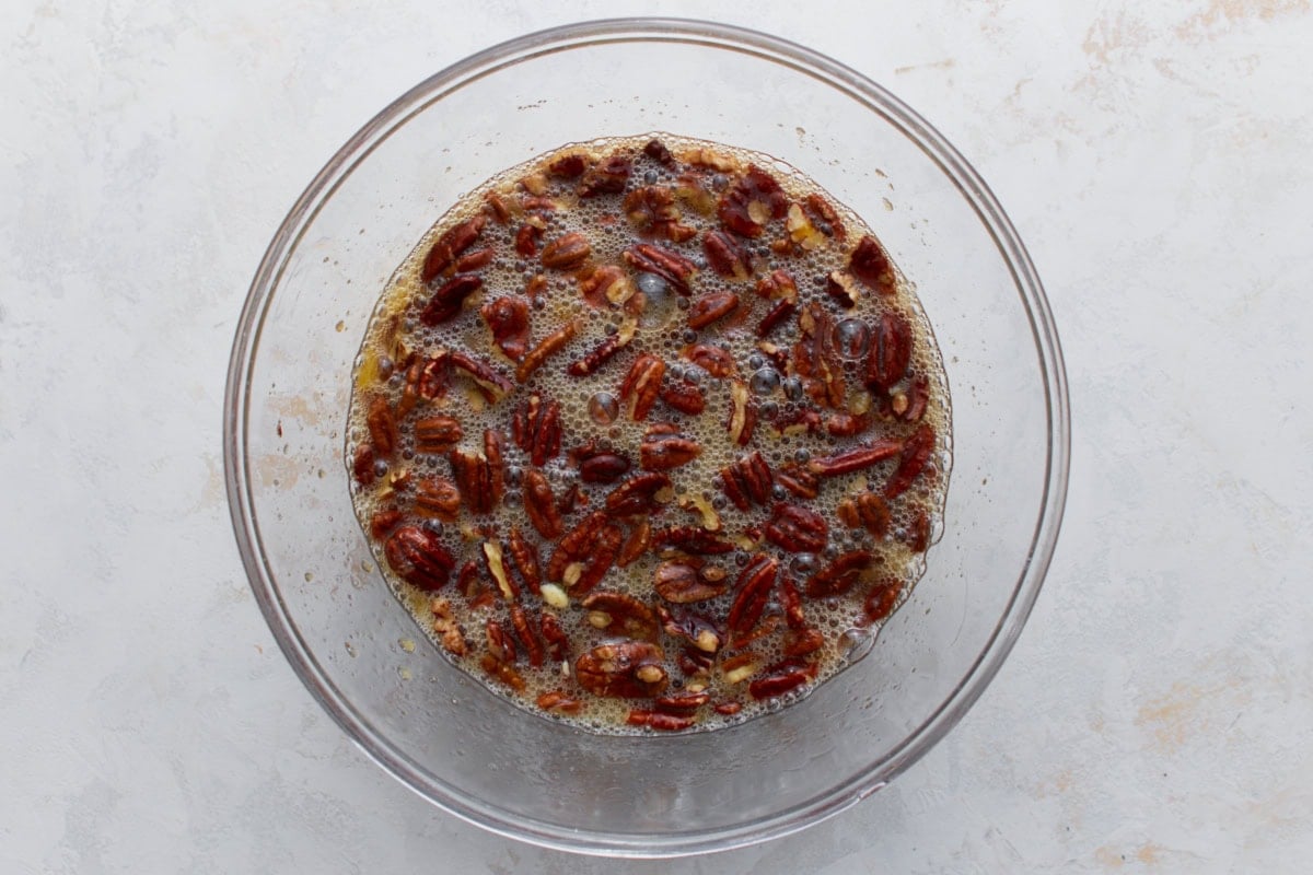 pecans being mixed into other ingredients for crustless pecan pie