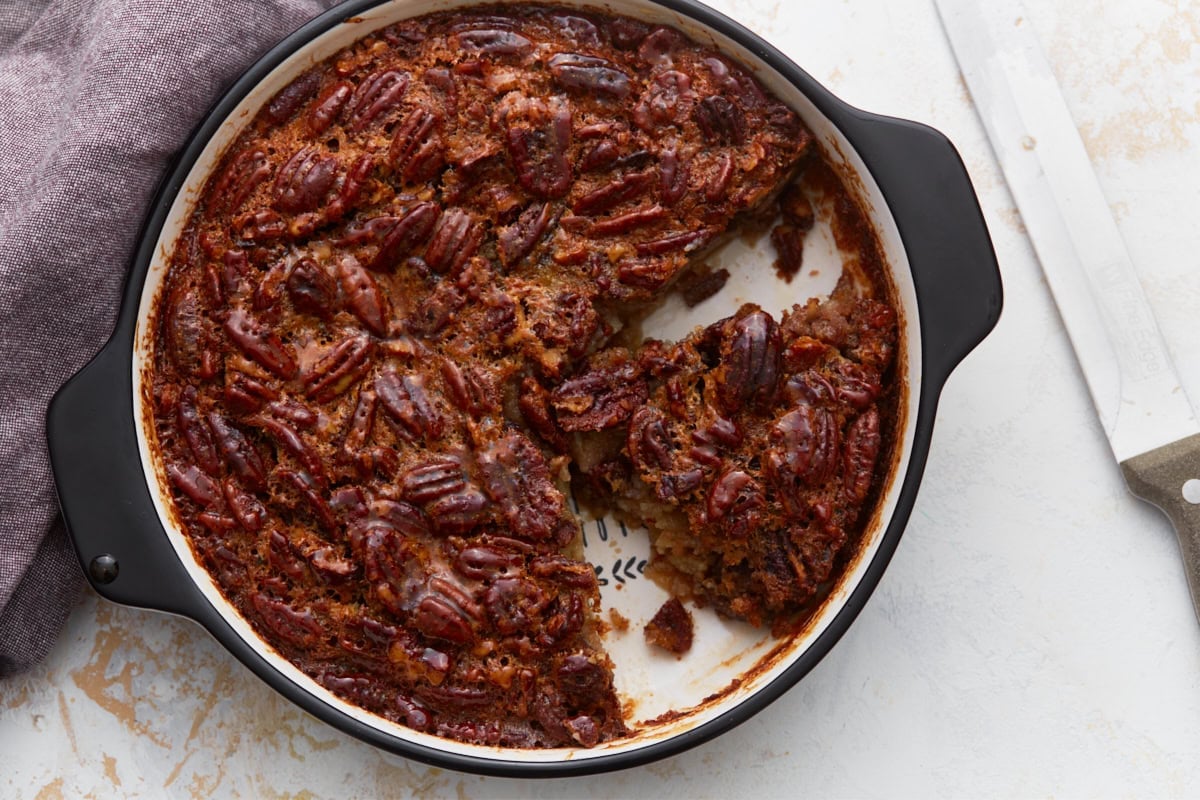 finished crustless pecan pie with a slice taken out