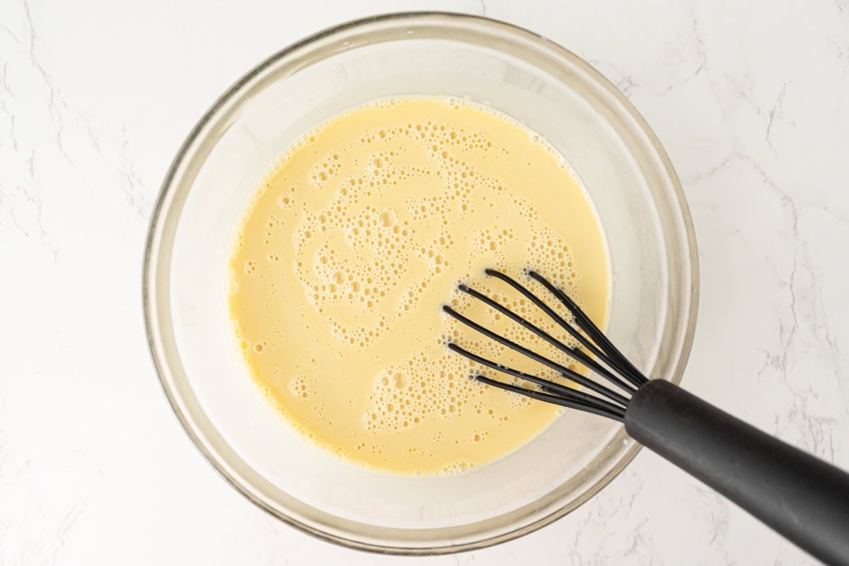 Smooth custard mixture after whisking coconut milk into egg yolks.