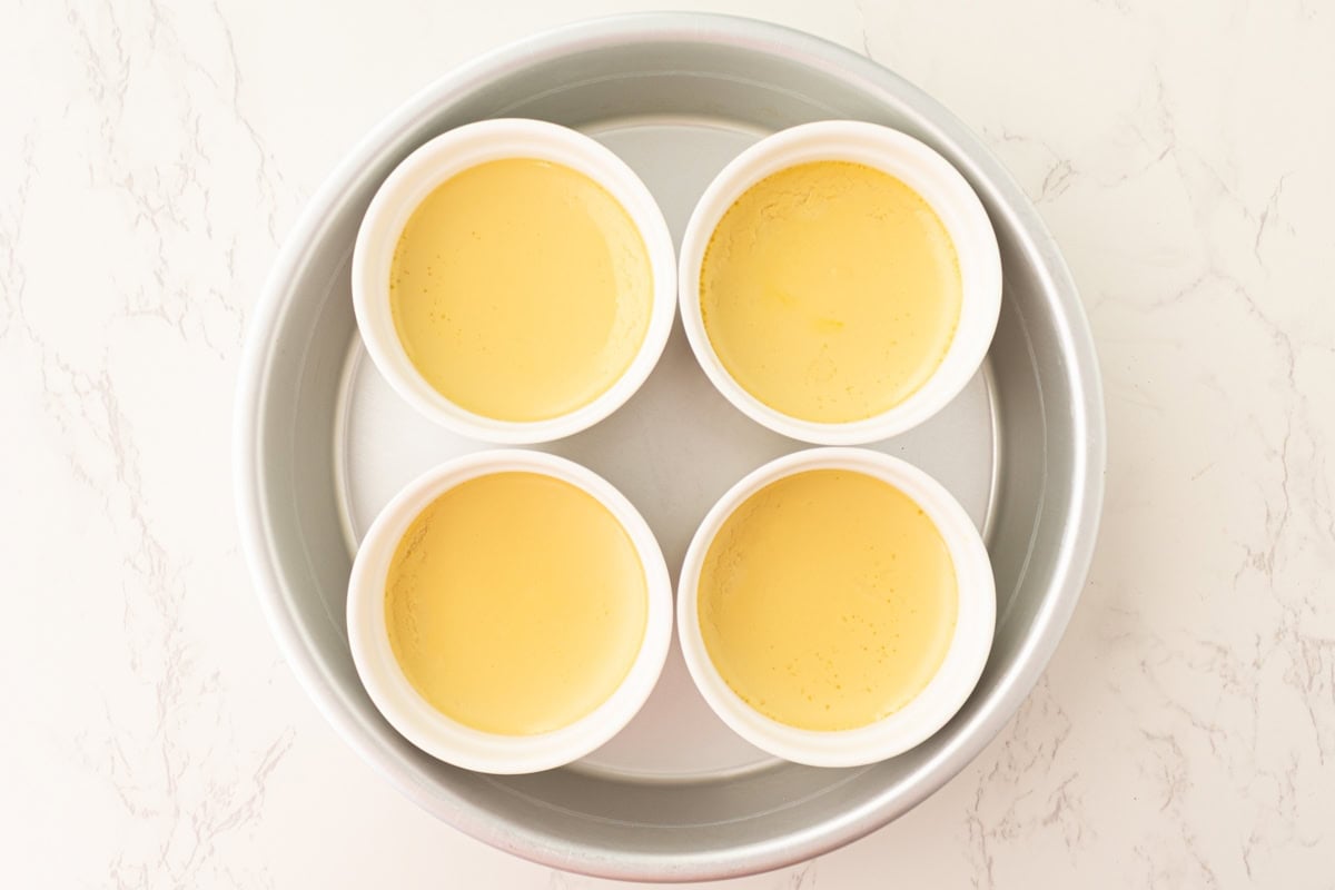 Dairy-free crème brûlée custards after baking, just set and pale yellow.