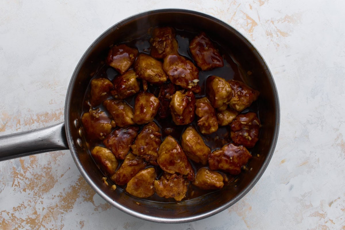Crispy fried chicken tossed in sweet and spicy gluten-free General Tso’s sauce in a skillet