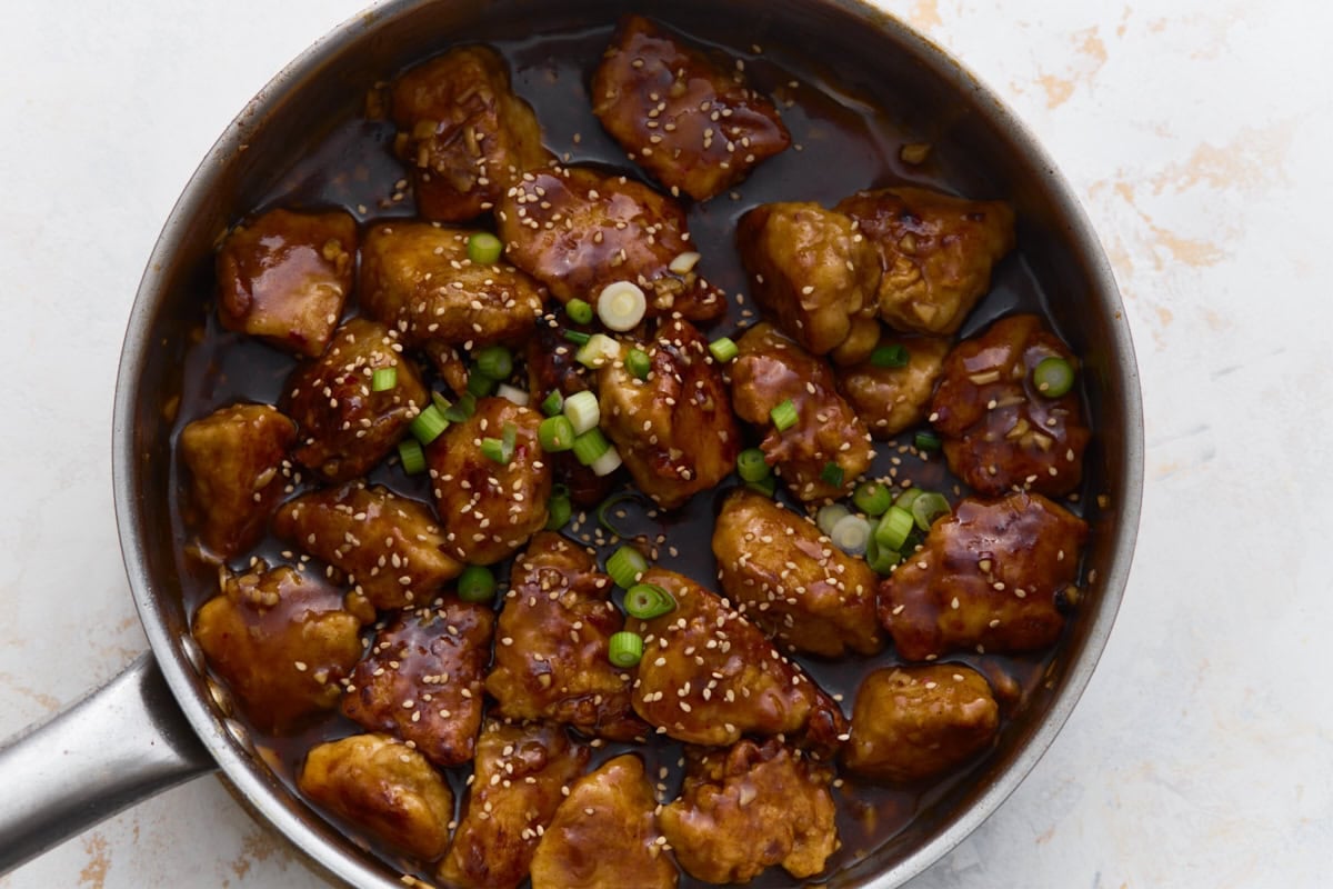 Overhead view of gluten-free General Tso’s chicken finished with sesame seeds and green onions