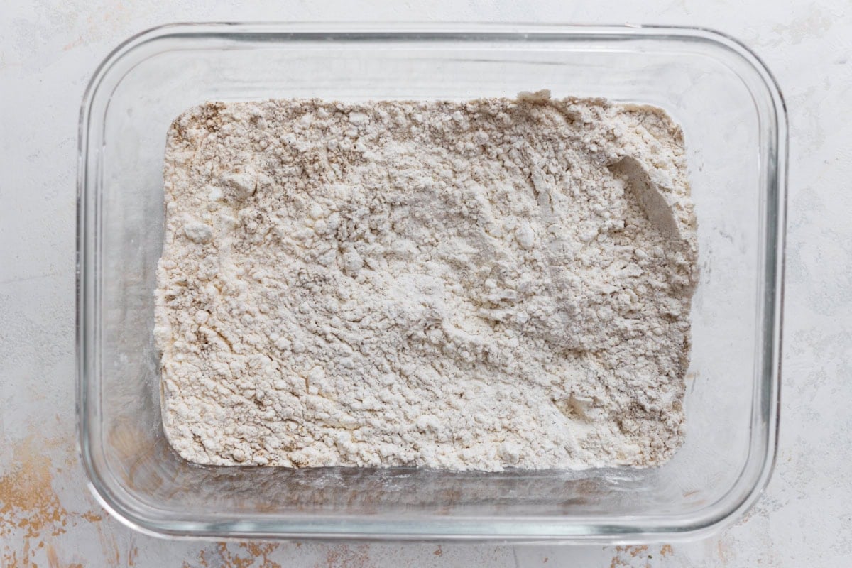 Cornstarch and gluten-free flour mixture for coating chicken in a glass baking dish
