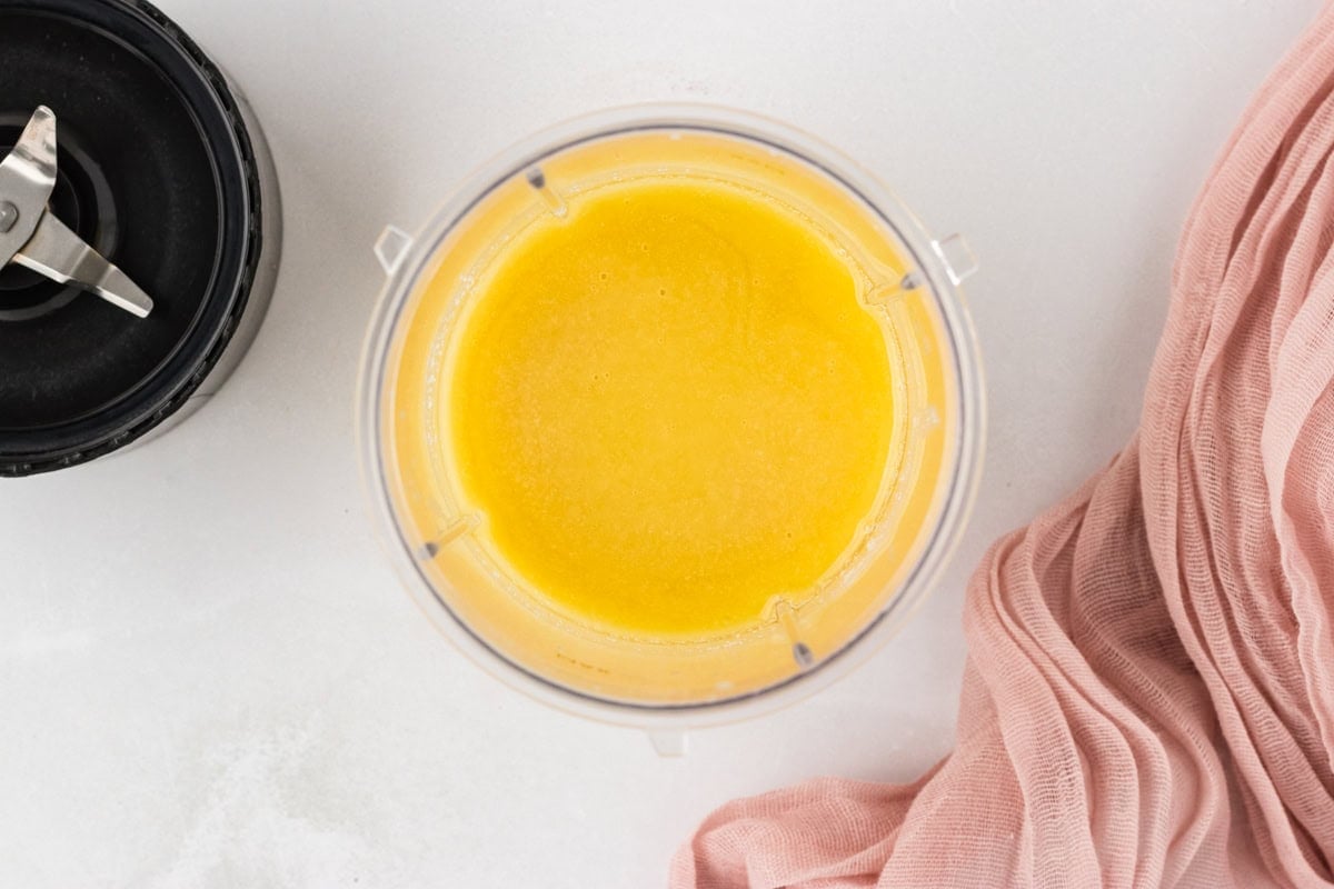 Warm chocolate mixture blended until smooth and glossy in a small blender container.