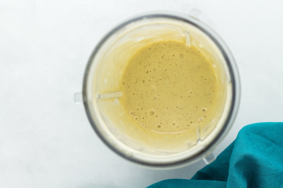 Dairy-free Caesar dressing blended until smooth and creamy inside a blender