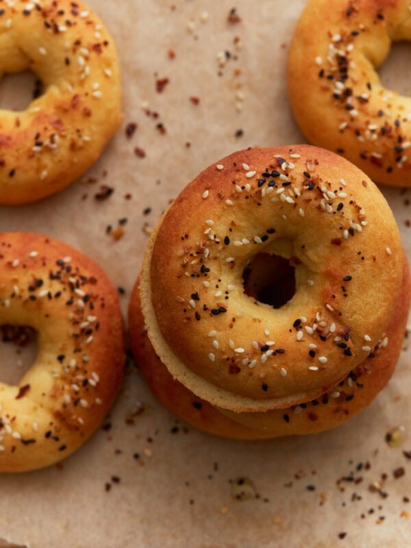 Keto bagels baked until golden brown and topped with everything bagel seasoning on parchment paper.