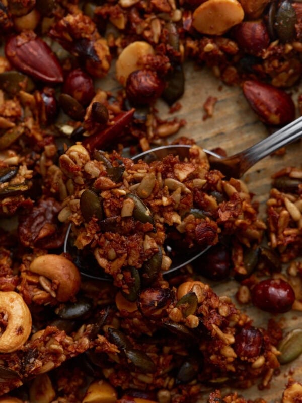 Close-up of baked keto granola clusters with mixed nuts and seeds, showing a crunchy texture and golden brown color.