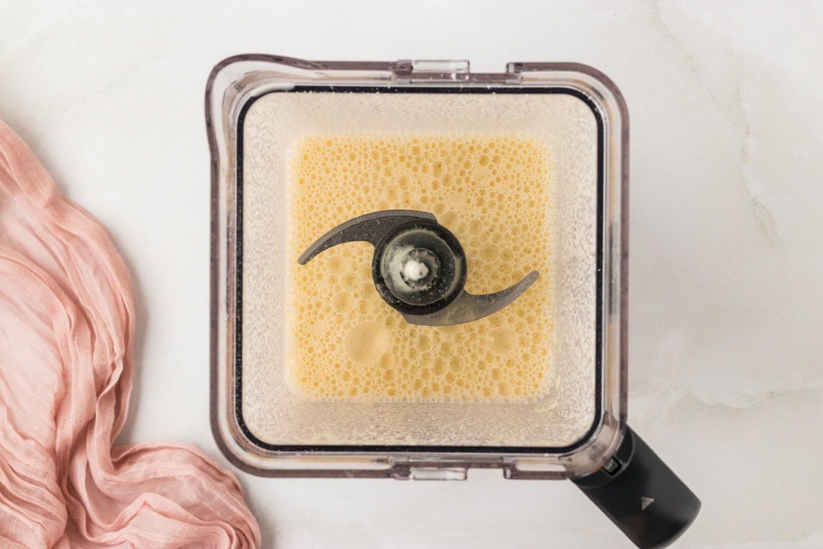 Blended almond flour crepe batter in a blender with a smooth, foamy texture