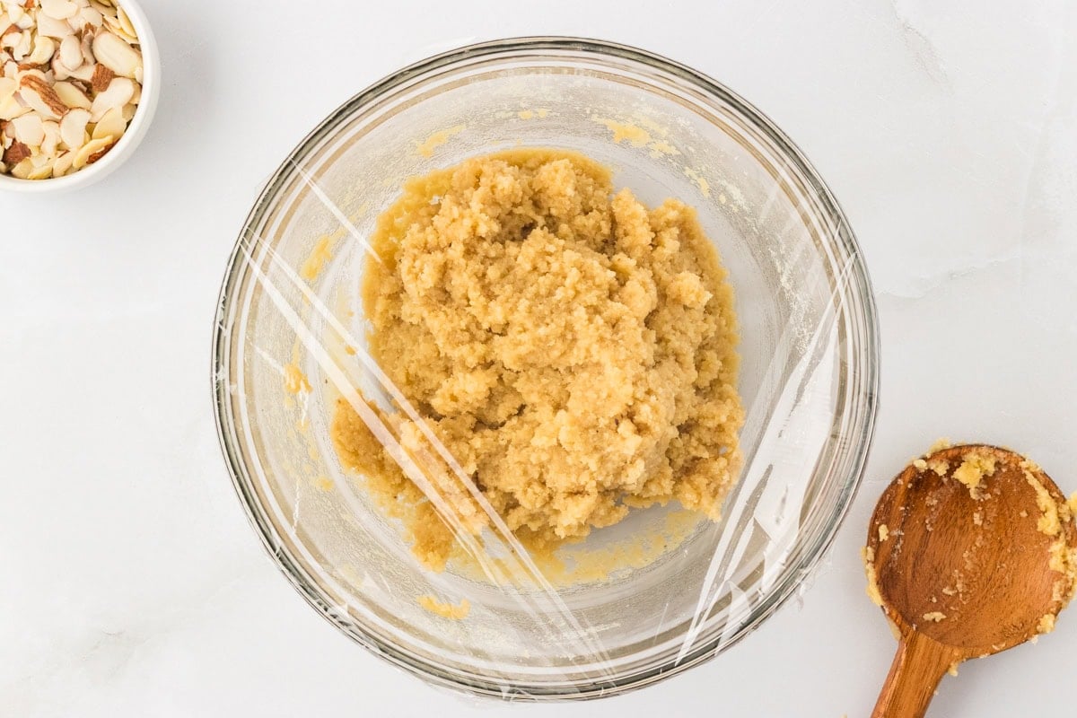 Almond flour scone dough wrapped in plastic wrap ready to chill