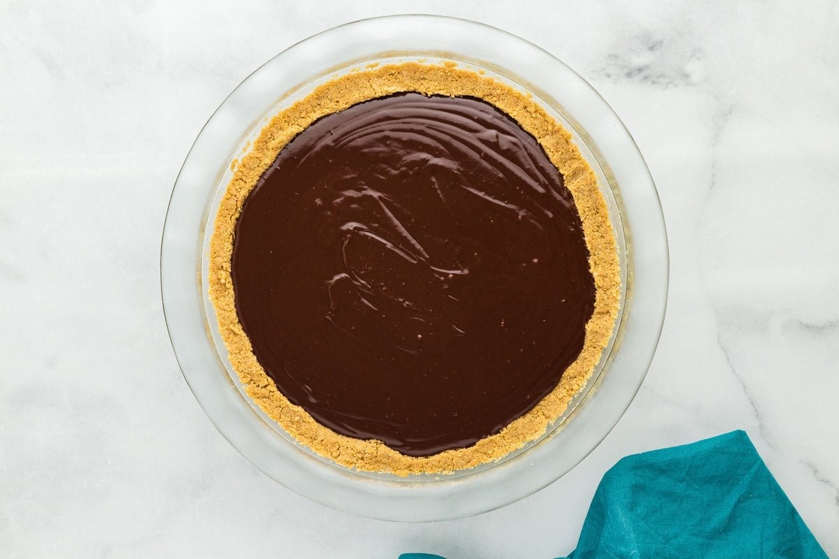 Gluten-free chocolate pie with smooth chocolate custard filling poured into a graham cracker crust.