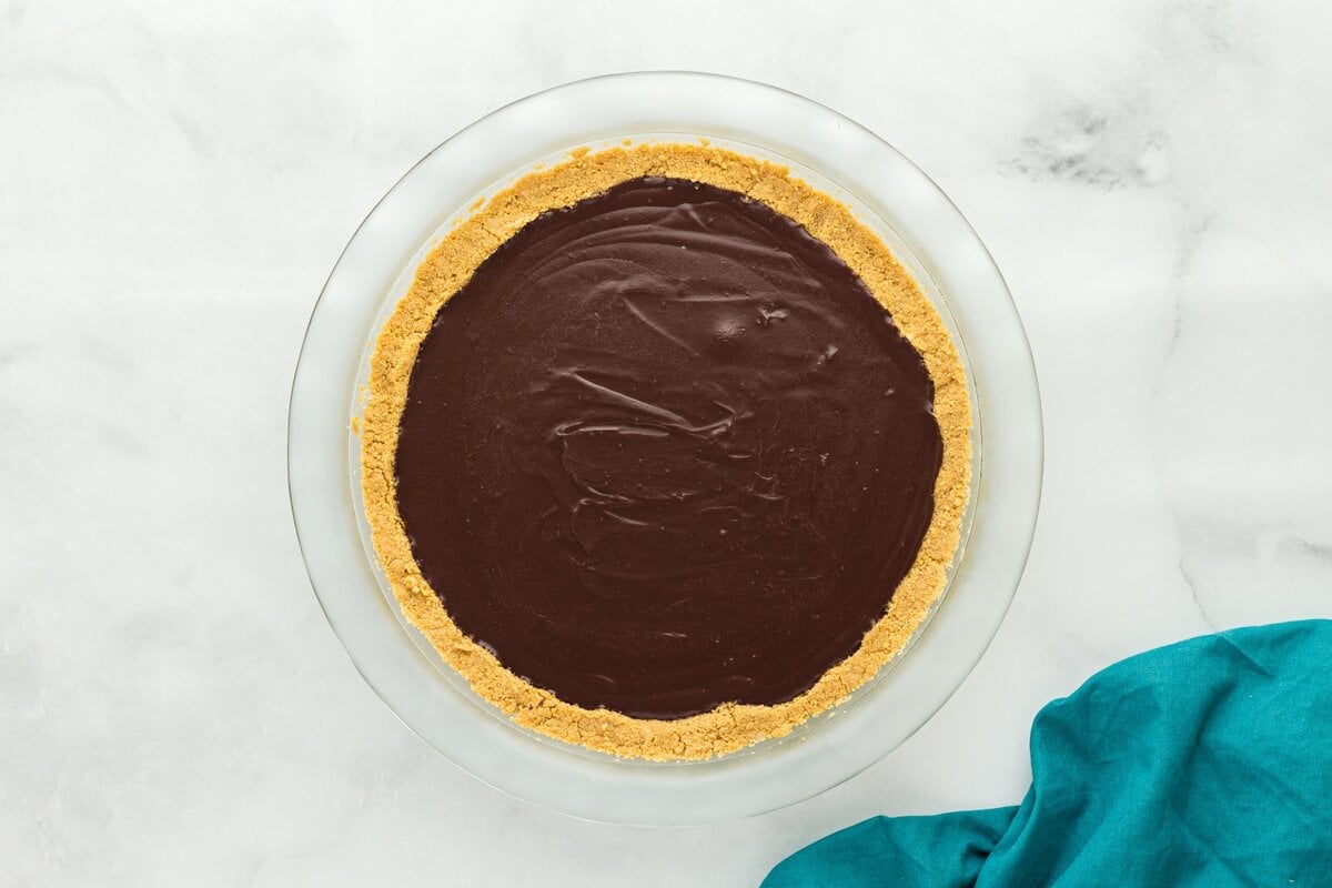 Chilled gluten-free chocolate pie with set chocolate custard filling and graham cracker crust.