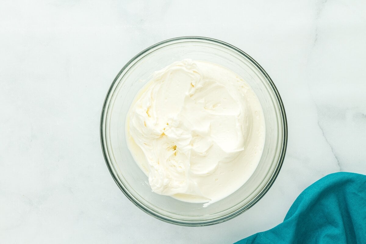 Lightly sweetened whipped cream in a glass bowl, whipped to soft peaks.