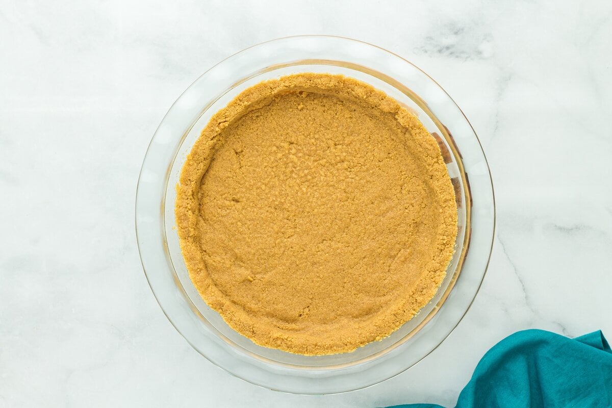 Baked gluten-free graham cracker crust cooled and ready for chocolate pie filling.