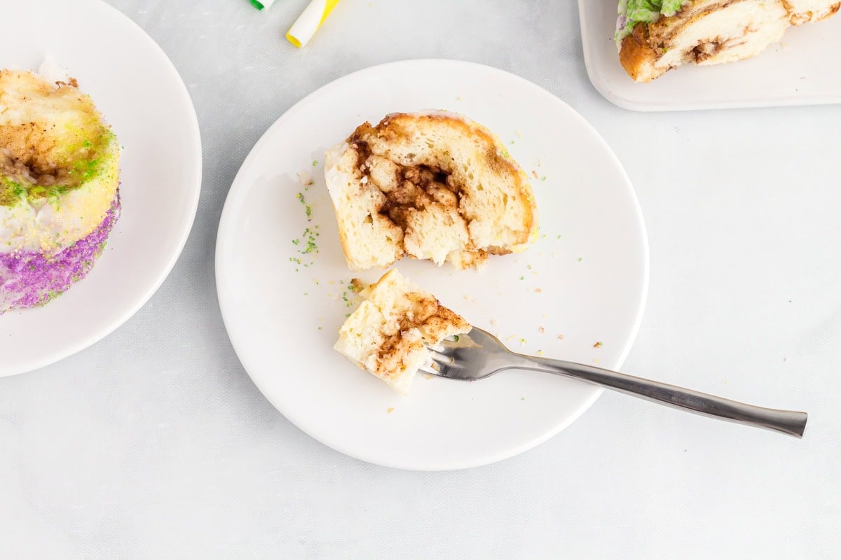 Bite of gluten free king cake on a fork showing the soft interior and cinnamon sugar layers.