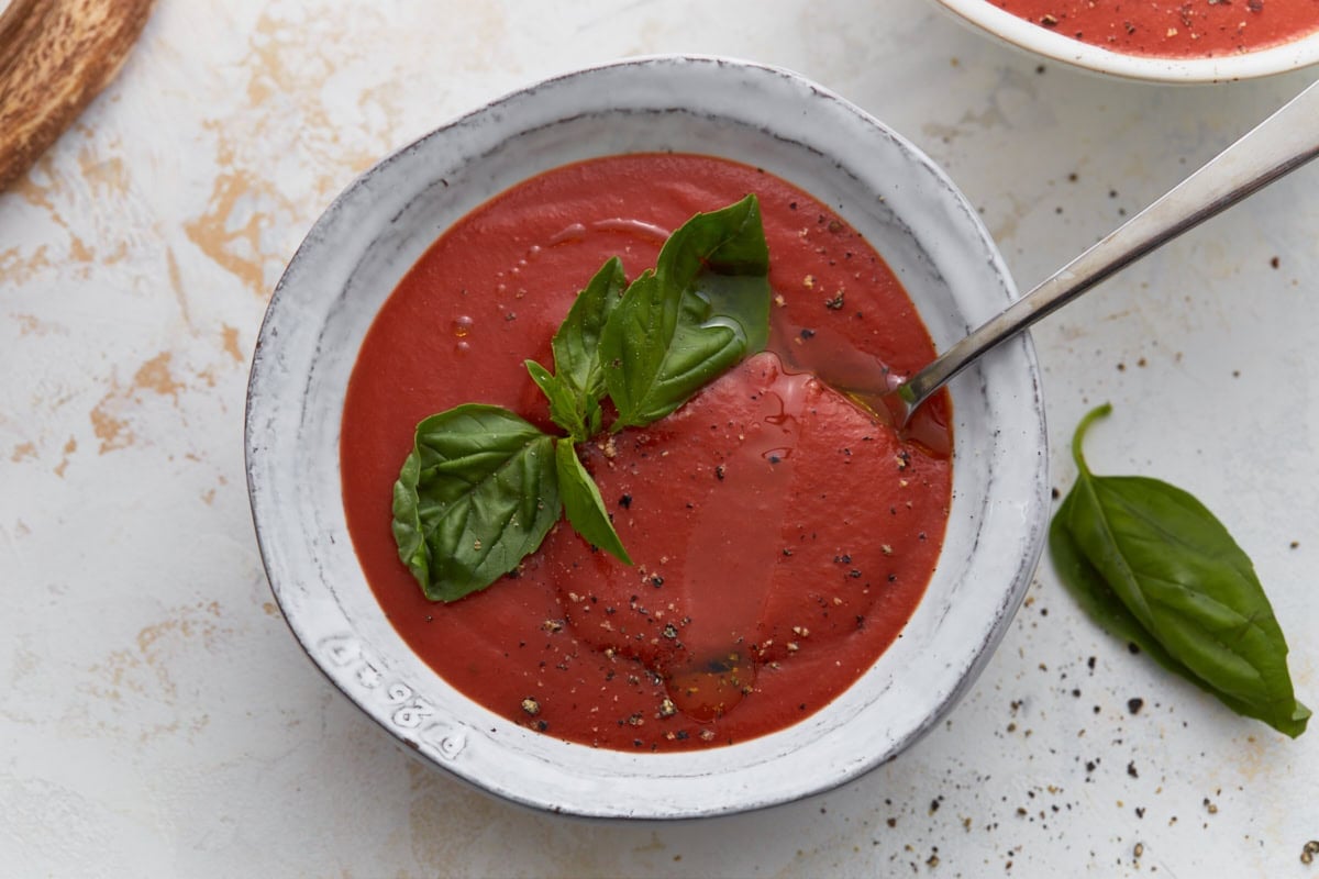 bowl of gluten-free tomato soup garnished with basil