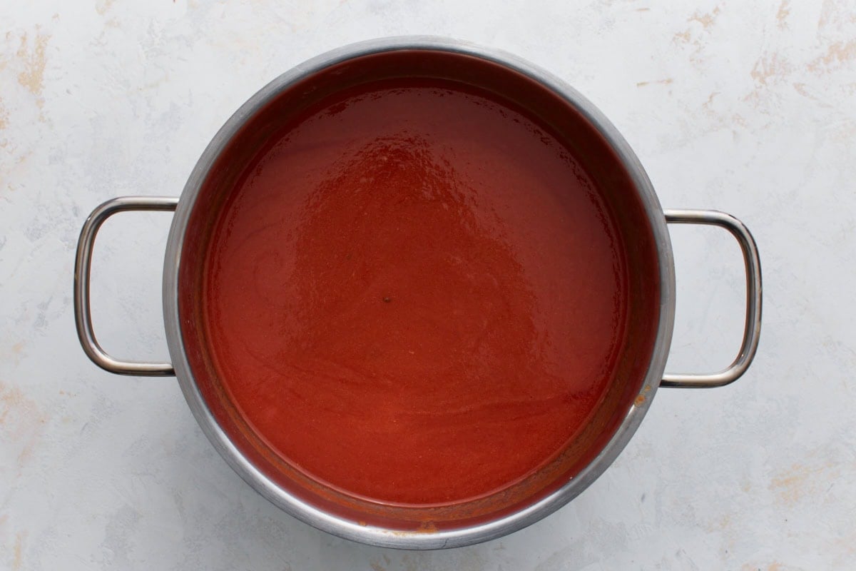 gluten-free tomato soup ingredients stirred together in a pot