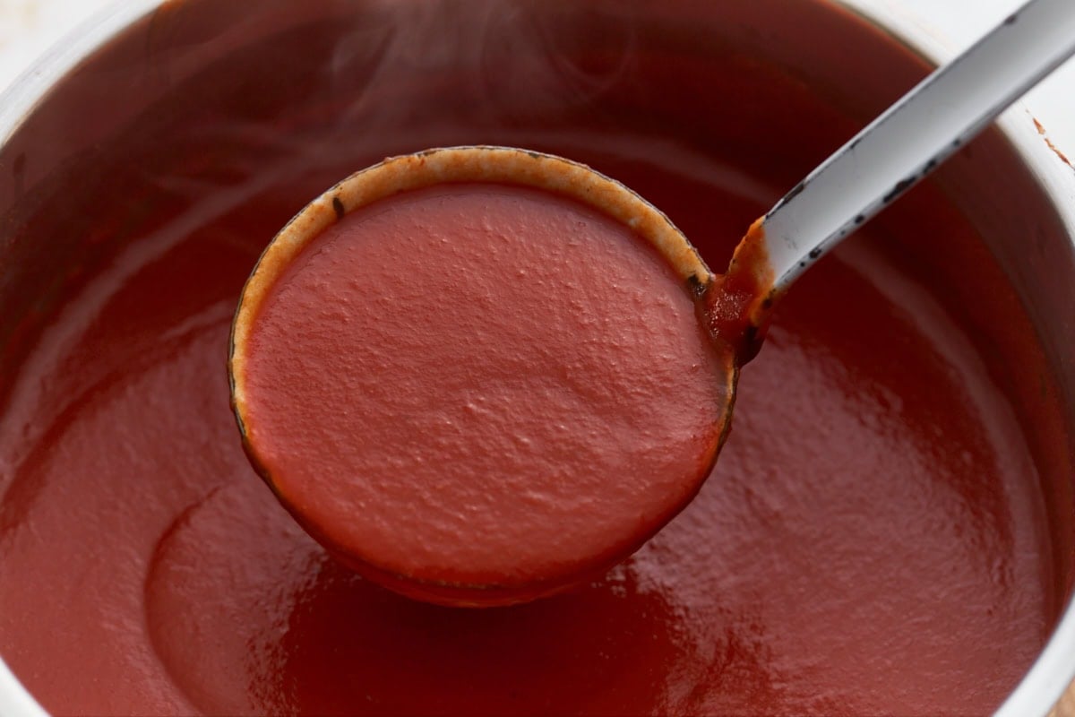 ladle spooning out scoop of gluten-free tomato soup