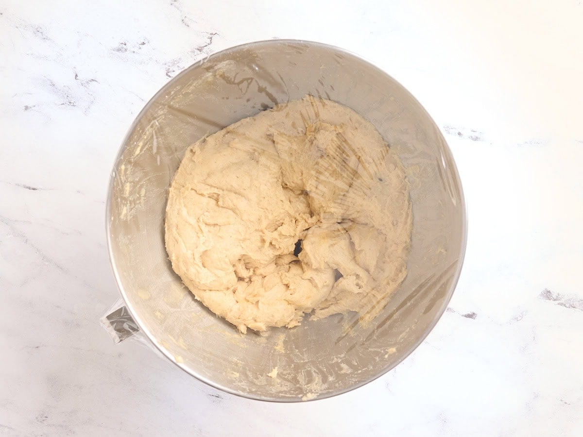 Gluten free challah bread dough covered with plastic wrap for the first rise.
