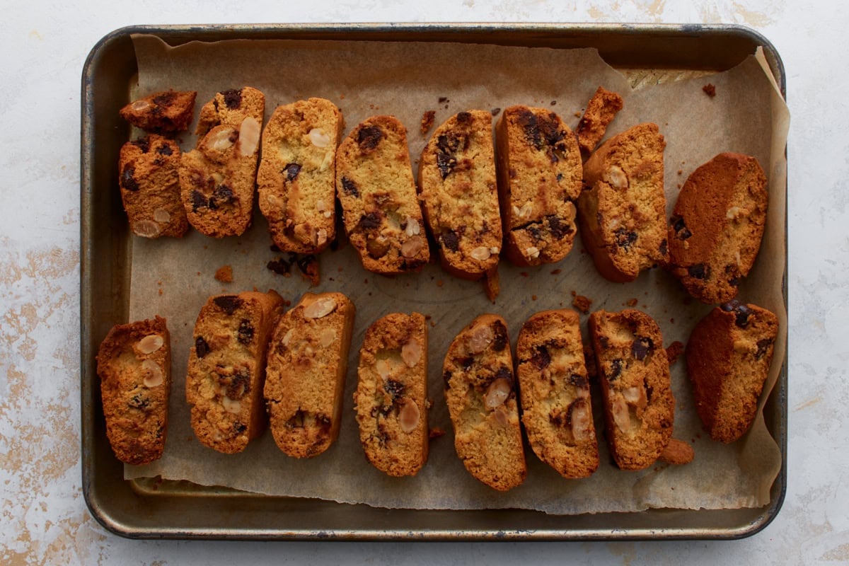 Almond flour biscotti slices arranged on a baking sheet before the second bake