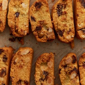 Close-up of sliced almond flour biscotti with chocolate chips and sliced almonds on parchment paper