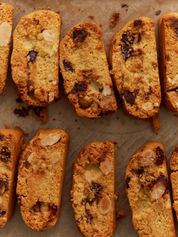 Close-up of sliced almond flour biscotti with chocolate chips and sliced almonds on parchment paper