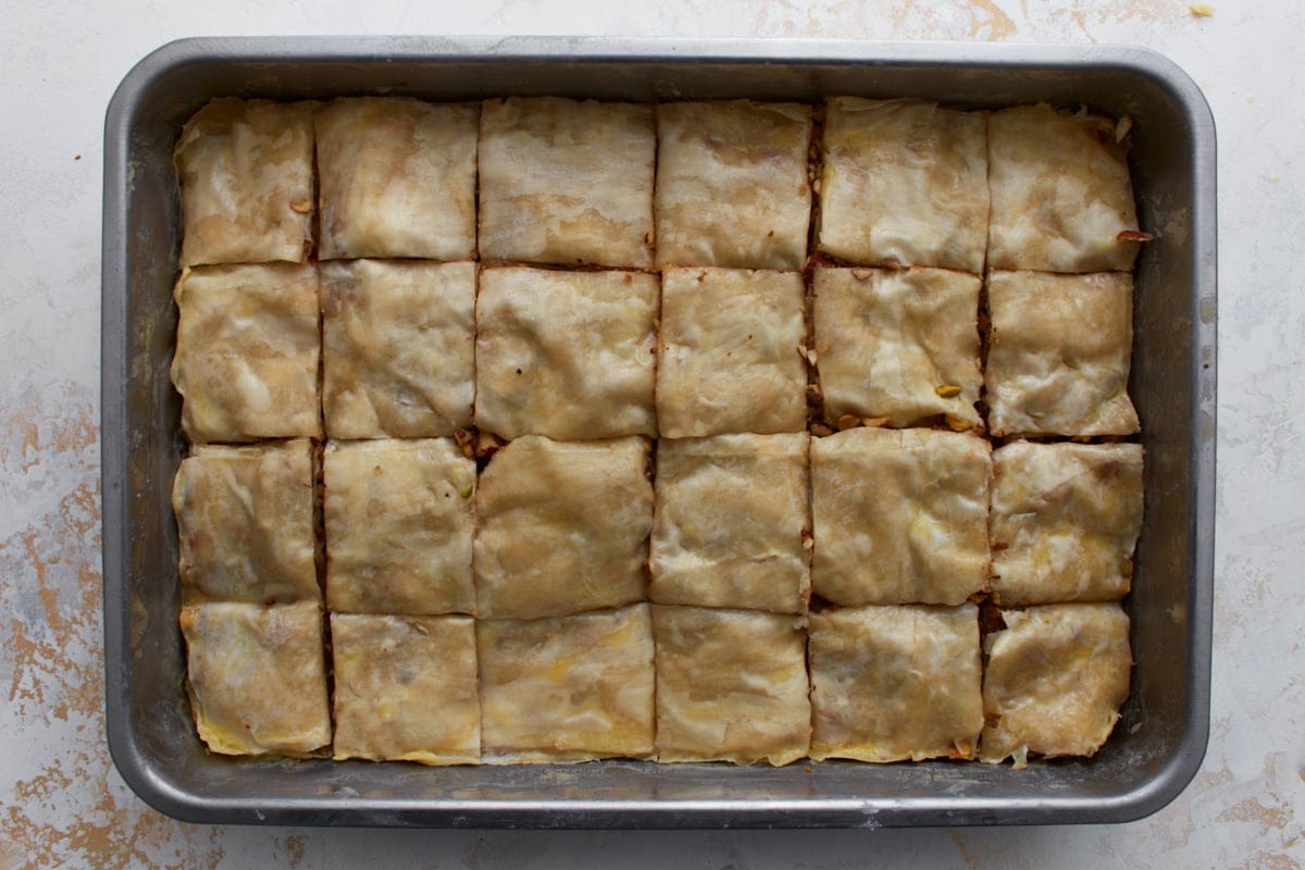 Gluten-free baklava cut into squares in a baking pan before baking.