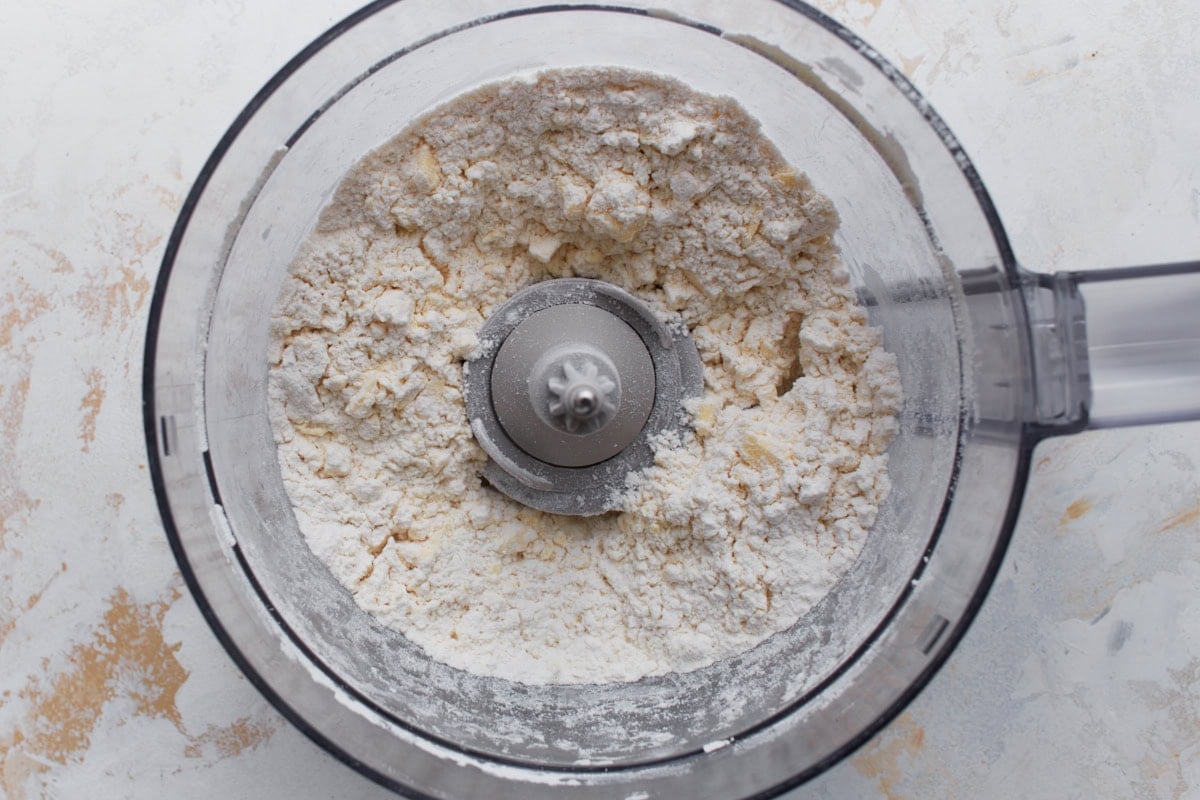 Gluten-free pie crust ingredients pulsed together in a food processor until crumbly