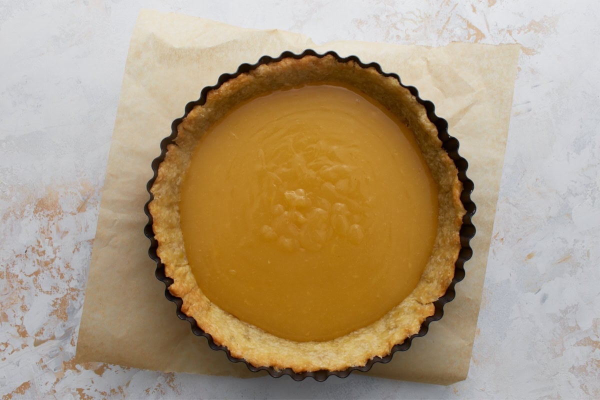 Hot lemon filling poured into a blind-baked gluten-free pie crust