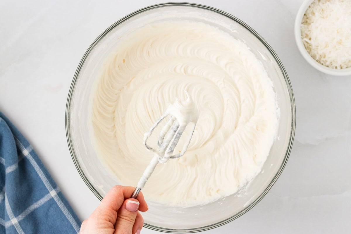 making the cream cheese frosting for gluten free coconut cake