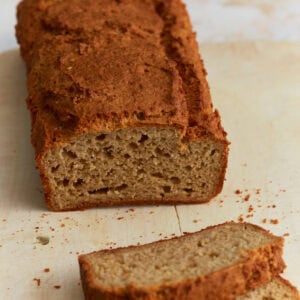 Sliced oat flour bread loaf showing soft, dense crumb and golden brown crust on a wooden cutting board