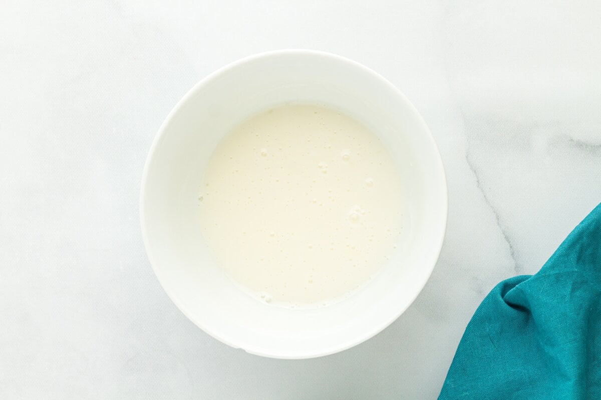 Simple lemon glaze made with powdered sugar and fresh lemon juice in white bowl